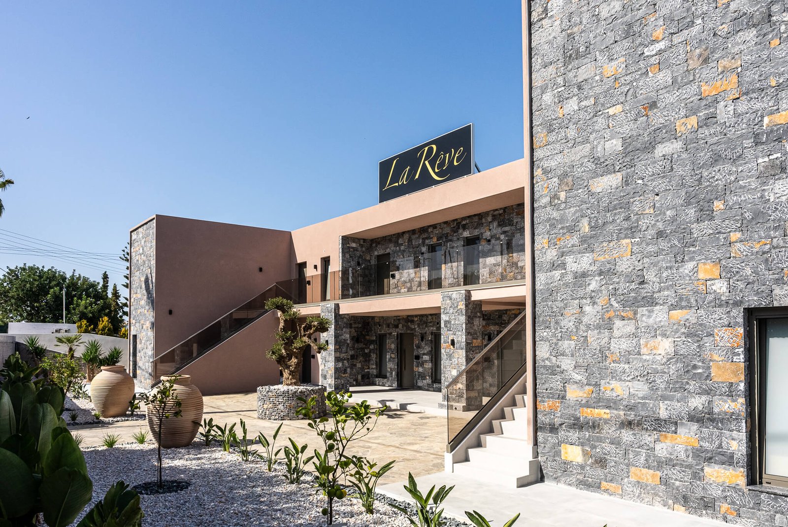 La Rêve — stone-clad façade with terracotta wall and Cretan courtyard